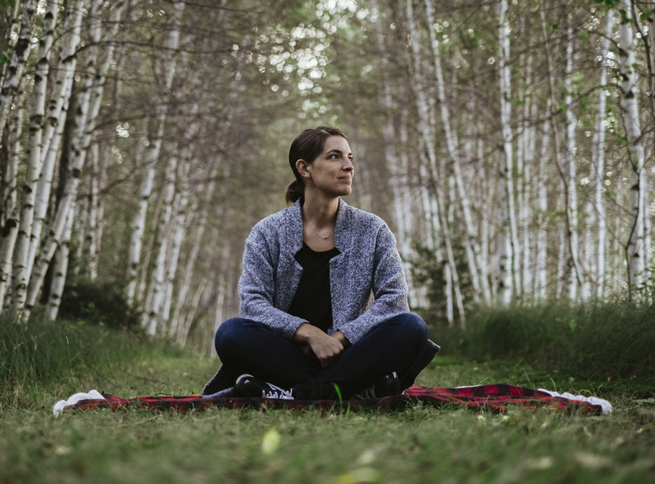 Person sitting on elevated path in fields at harvest